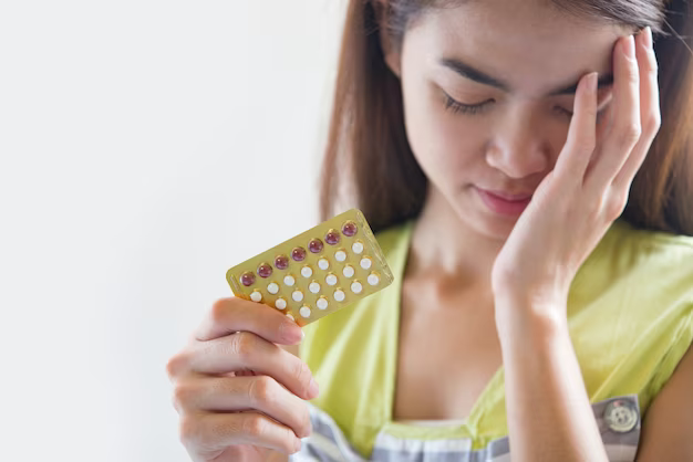 Girl holding a package of pills